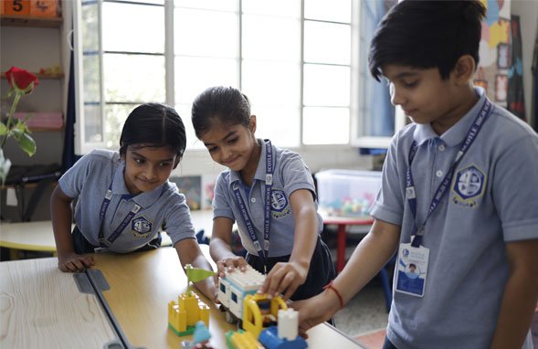 Students engaged in hands-on learning with creative materials