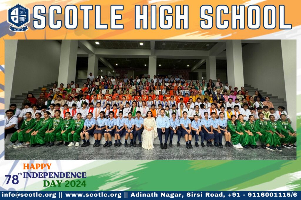 A group of students and staff pose for a photo in the auditorium with 'Scotle High School' displayed above them, celebrating Independence Day 2024.